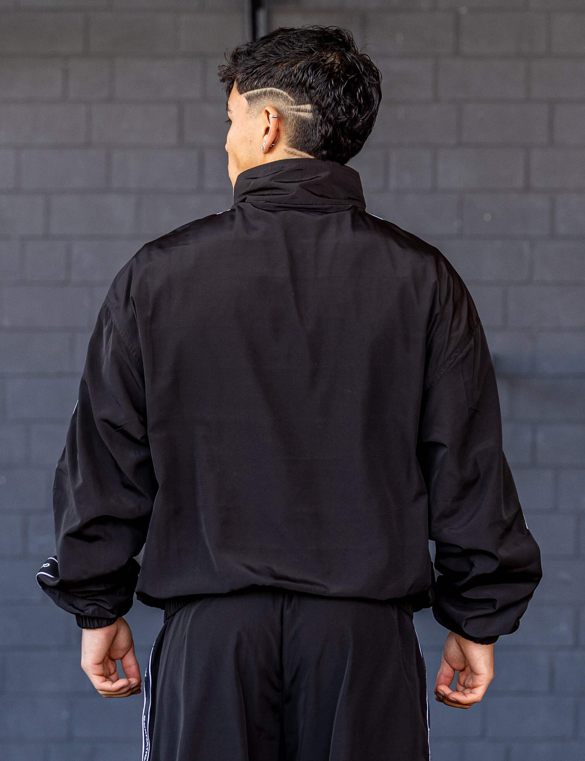 GORNATION athlete wearing the GORNATION tracksuite jacket in black