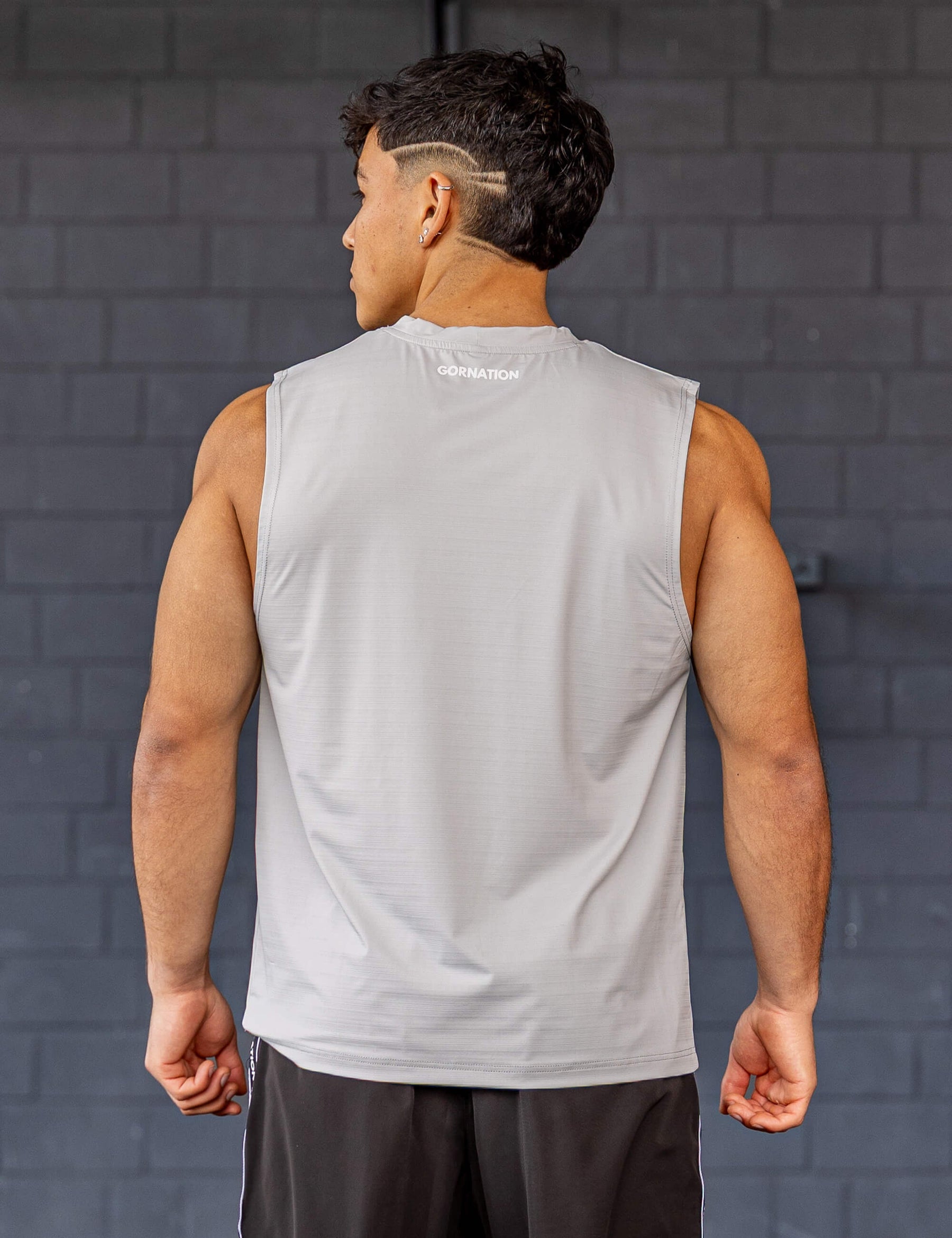 GORNATION athlete wearing the GORNATION active tank top in grey