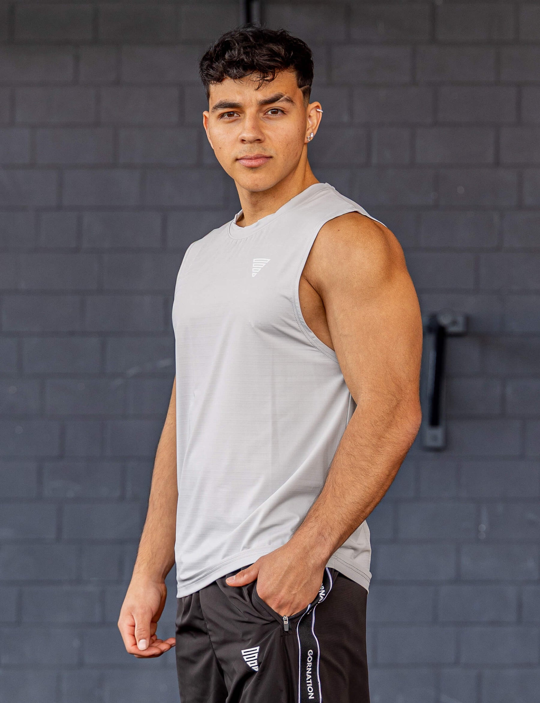 GORNATION athlete wearing the GORNATION active tank top in grey
