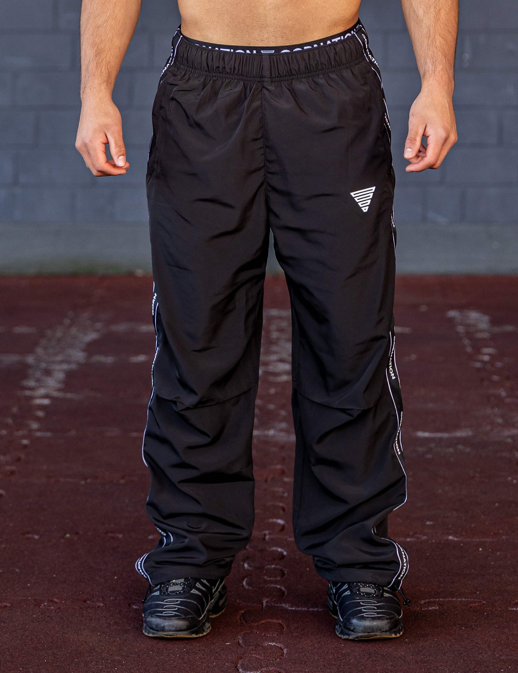 GORNATION athlete wearing the GORNATION tracksuite pants in black