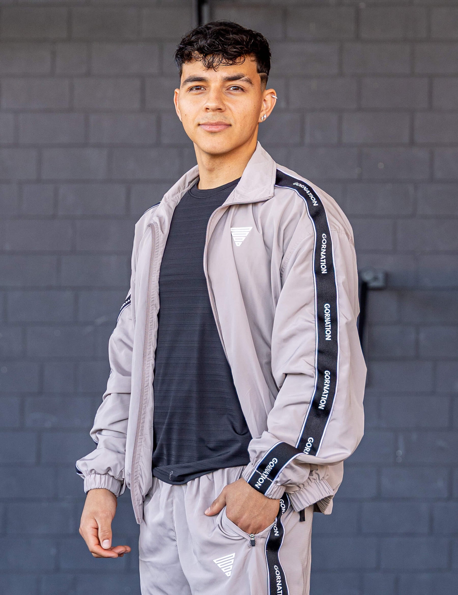 GORNATION athlete wearing the GORNATION tracksuite jacket in grey