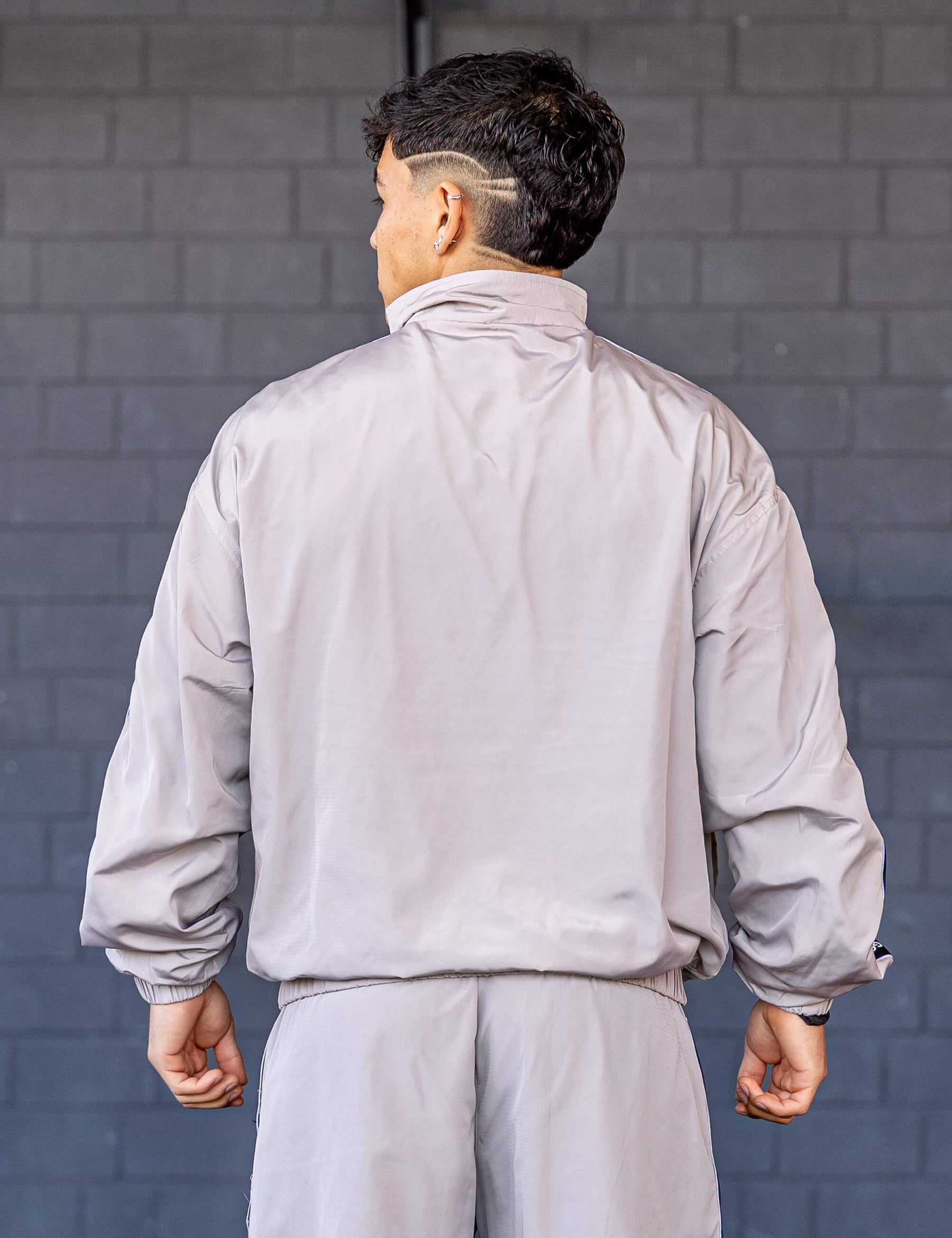 GORNATION athlete wearing the GORNATION tracksuite jacket in grey