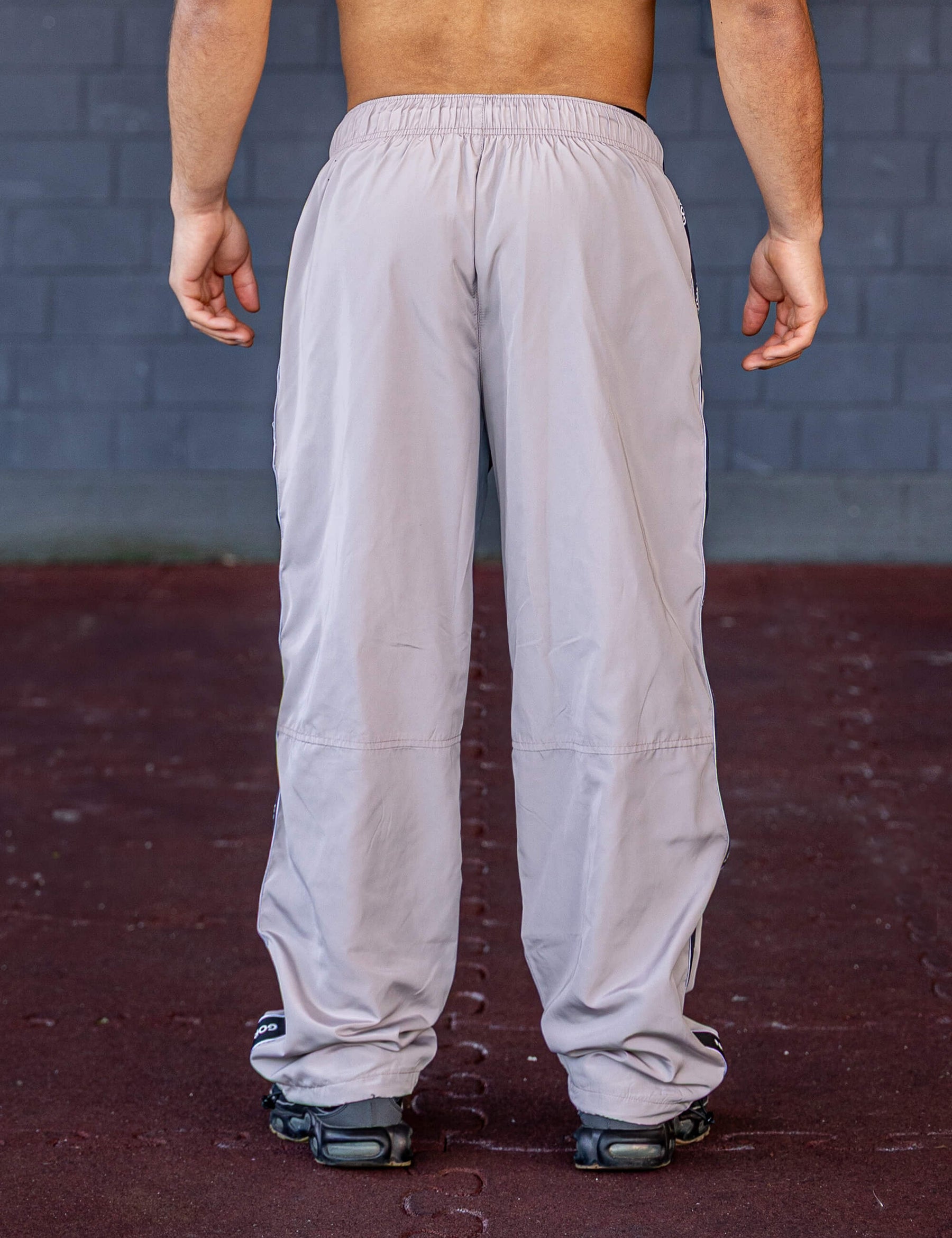 GORNATION athlete wearing the GORNATION tracksuite pants in grey