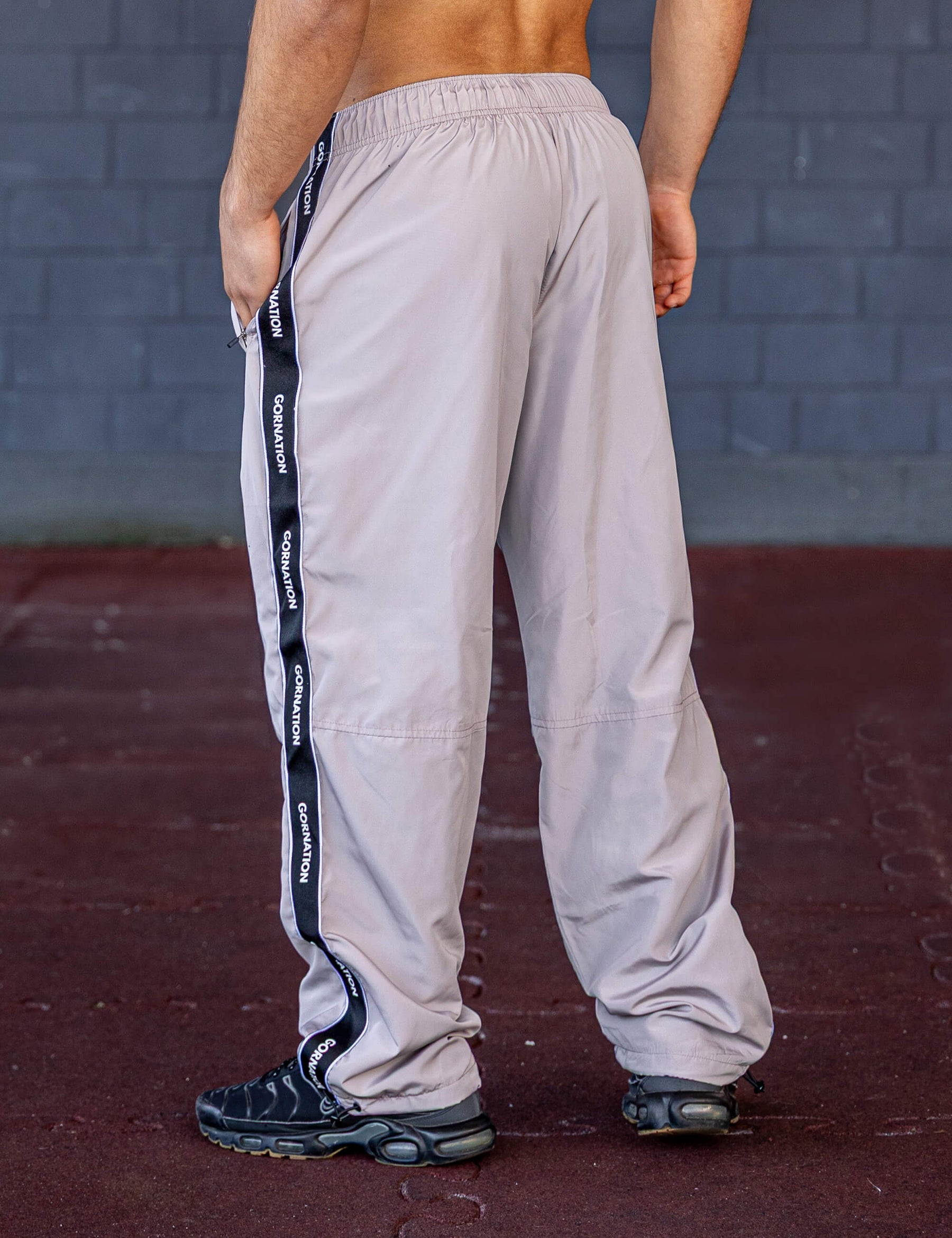 GORNATION athlete wearing the GORNATION tracksuite pants in grey