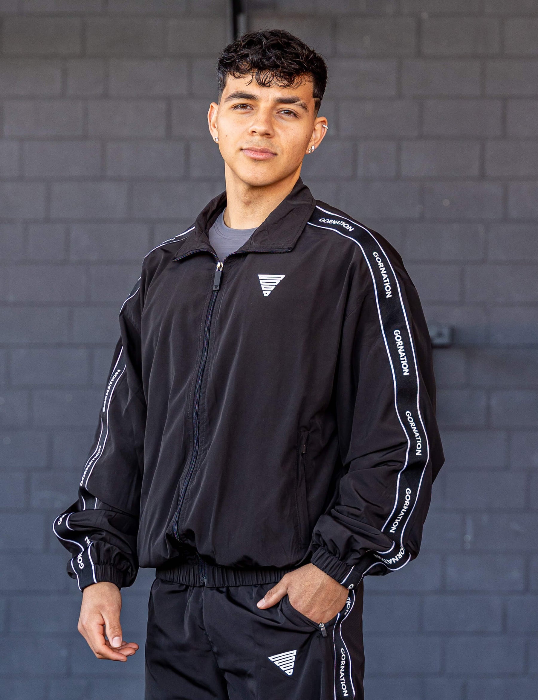 GORNATION athlete wearing the GORNATION tracksuite jacket in black