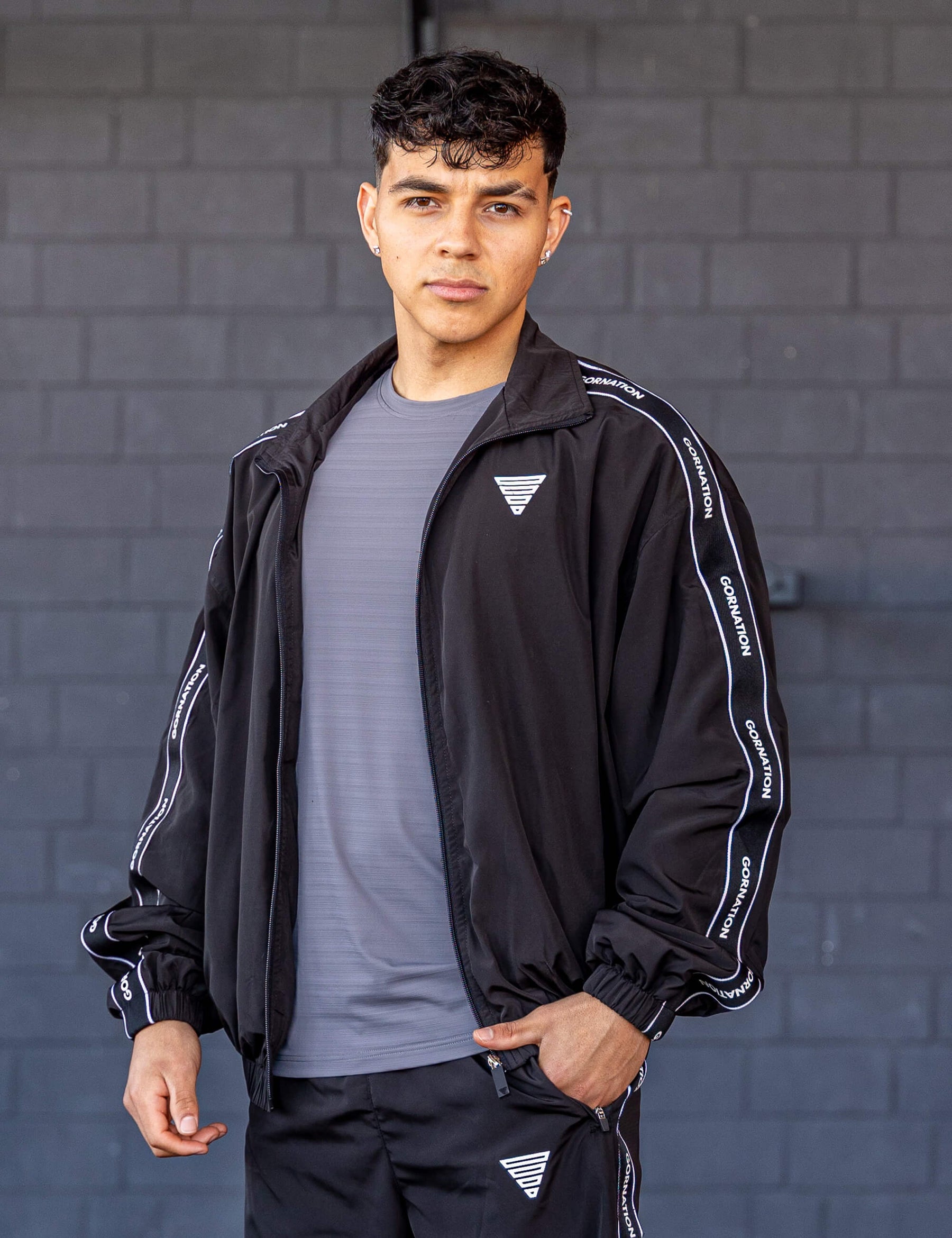 GORNATION athlete wearing the GORNATION tracksuite jacket in black