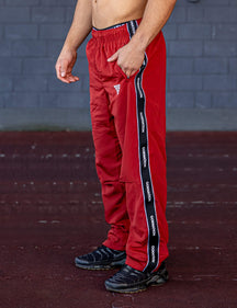GORNATION athlete wearing the GORNATION tracksuite pants in red