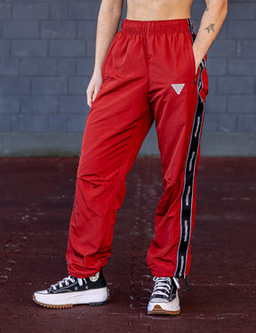 GORNATION athlete wearing the GORNATION tracksuite pants in red