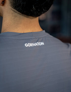 Close up of a GORNATION athlete wearing the GORNATION active t-shirt in grey