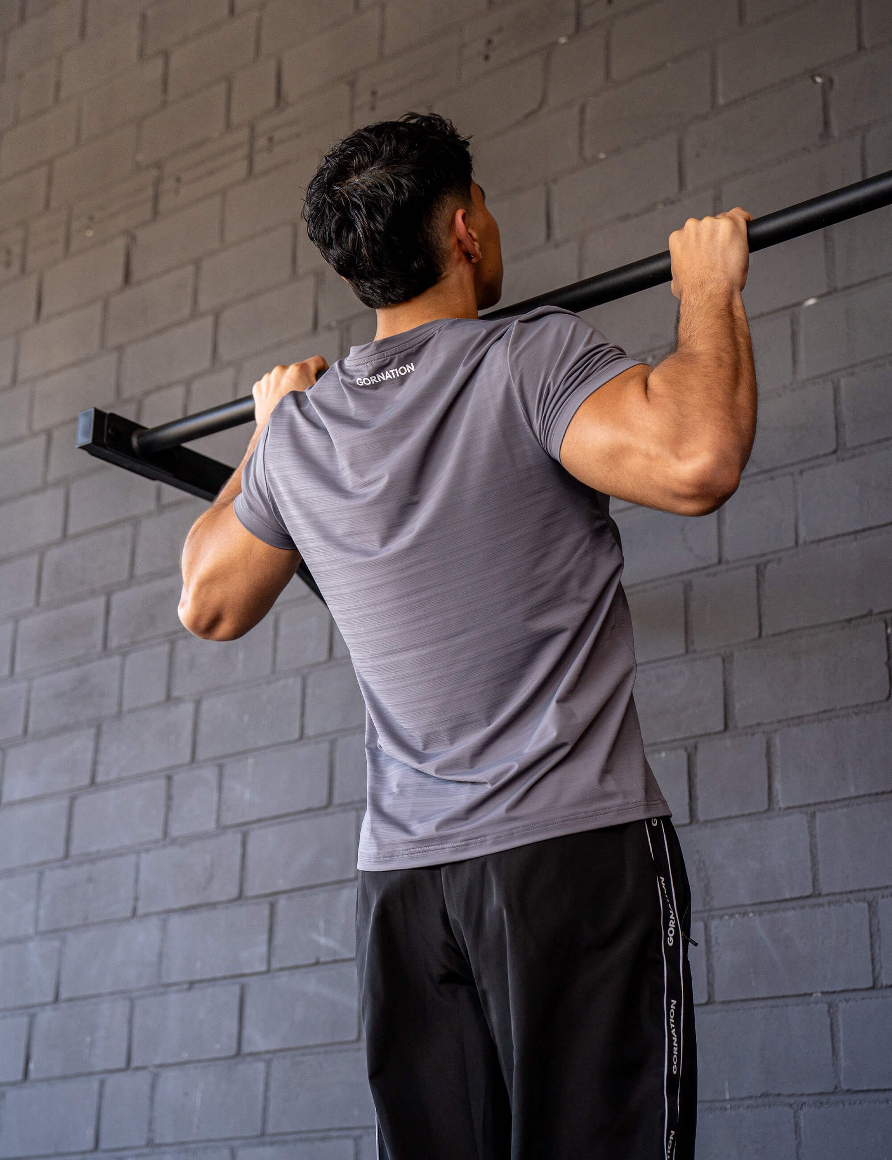 GORNATION athlete doing pull ups with a GORNATION pull up bar wearing an active t-shirt