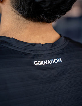 Close up of a GORNATION athlete wearing the GORNATION active tank top in black