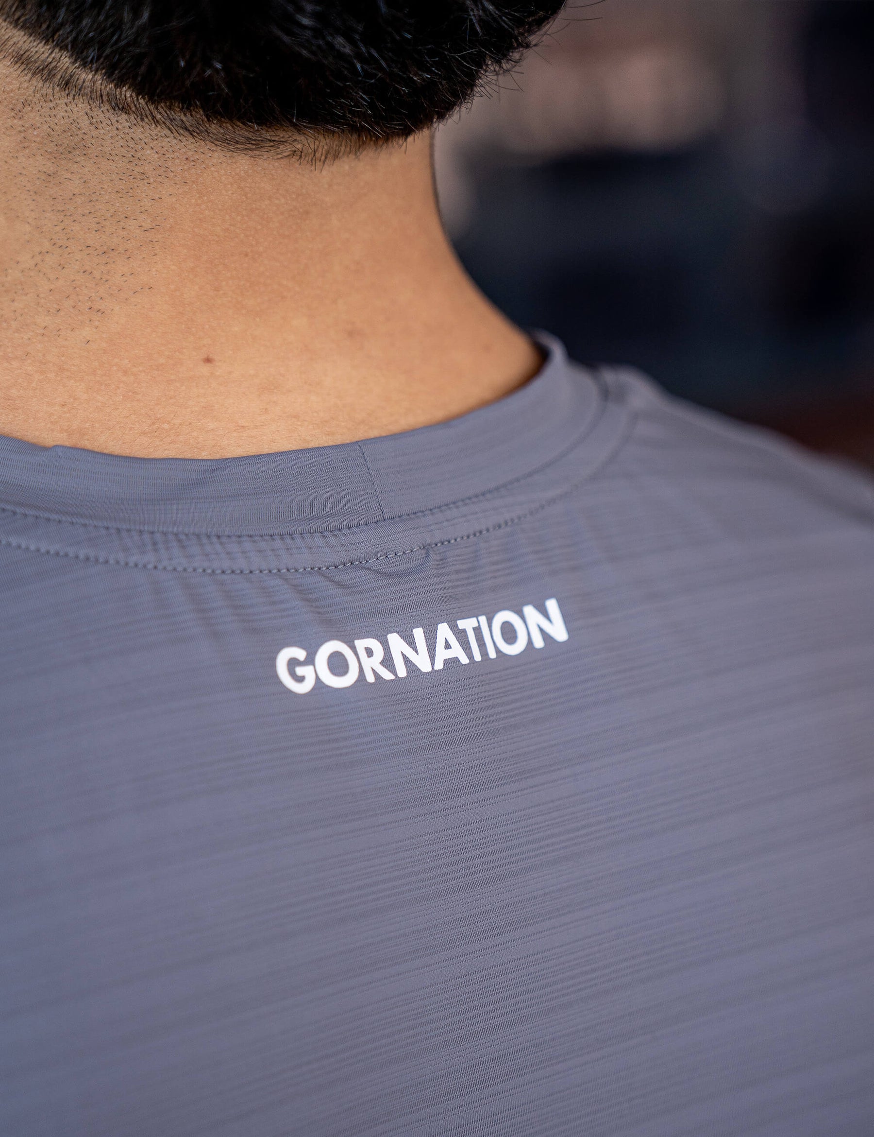 Close up of a GORNATION athlete wearing the GORNATION active tank top in grey