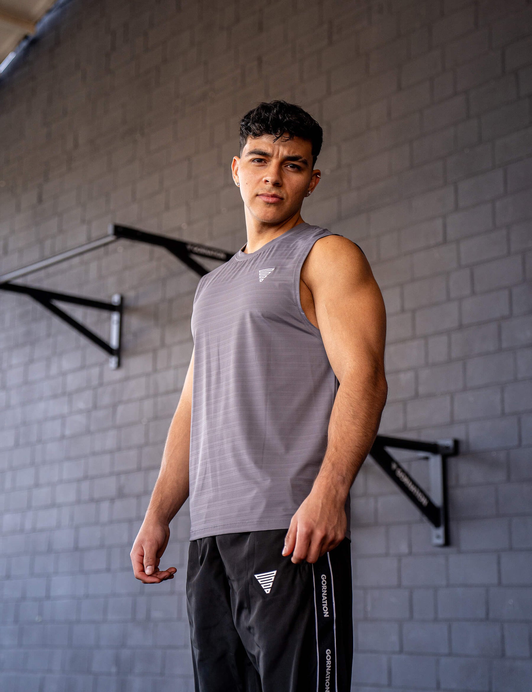 GORNATION athlete wearing the GORNATION active tank top in grey