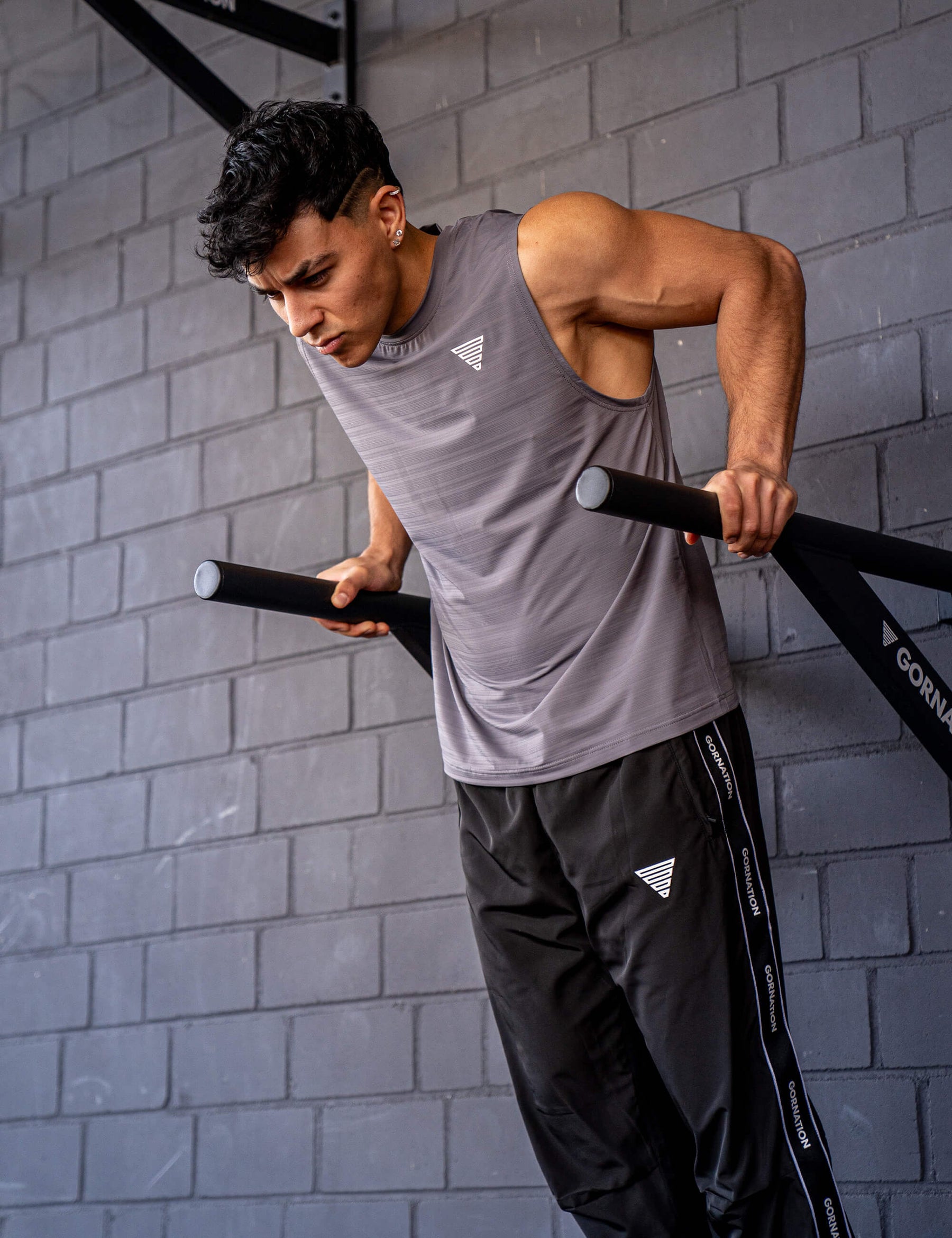GORNATION athlete doing dips with GORNATION dip bars wearing an active tank top 