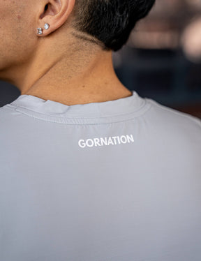Close up of a GORNATION athlete wearing the GORNATION active tank top in grey