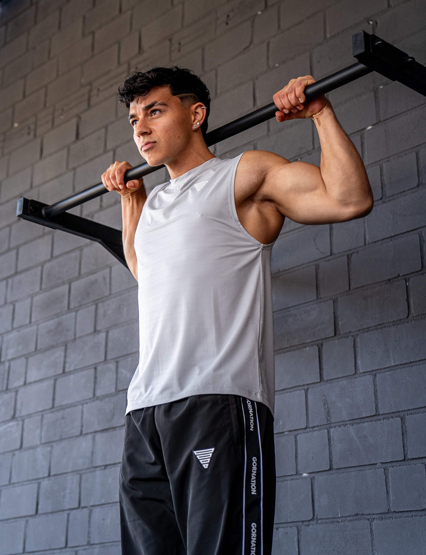 GORNATION athlete doing pull ups with a GORNATION pull up bar wearing an active tank top 