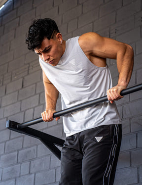 GORNATION athlete doing muscle ups with a GORNATION pull up bar wearing an active tank top 