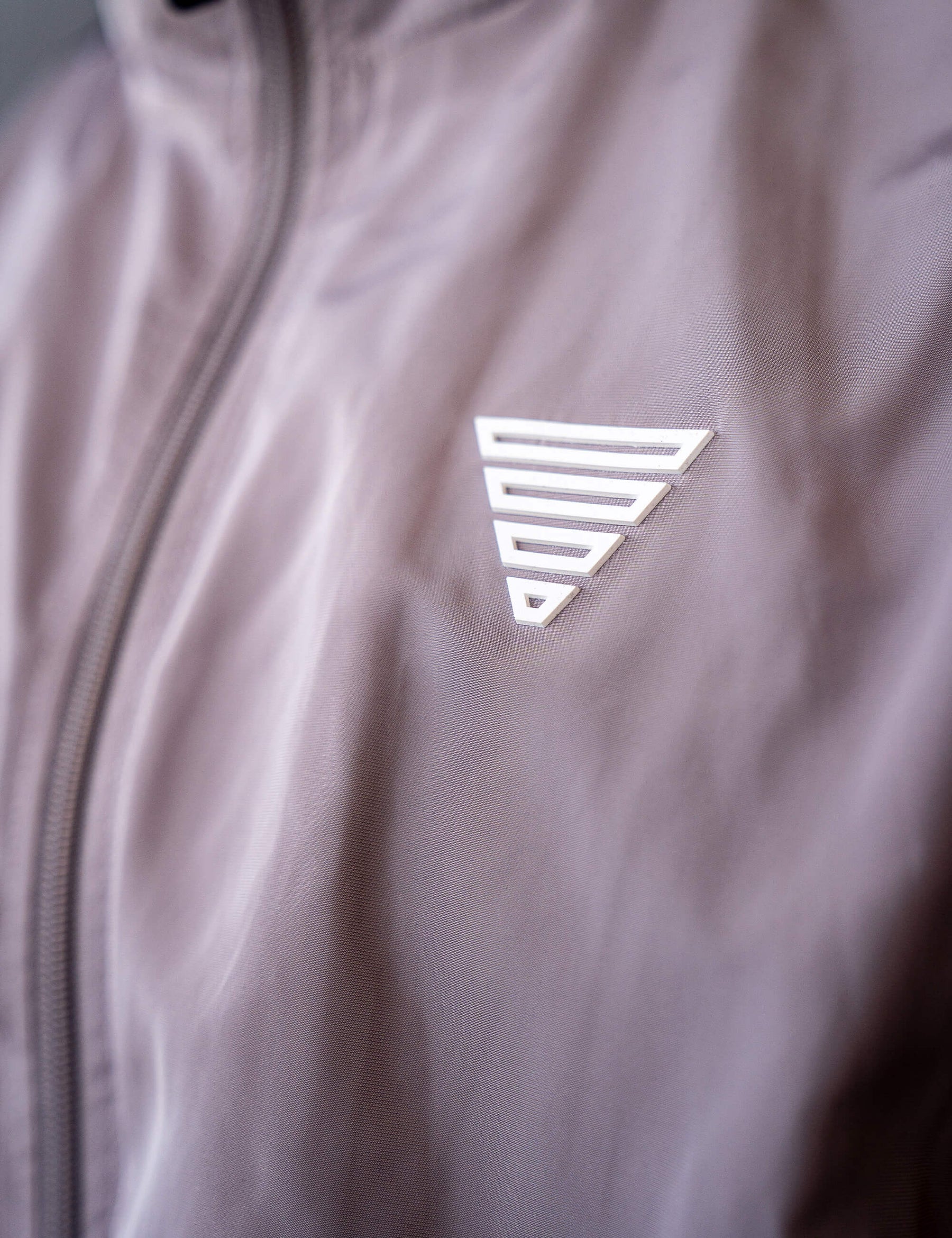 Close up of a GORNATION athlete wearing the GORNATION tracksuite jacket in grey
