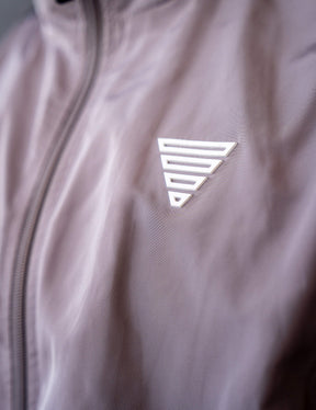 Close up of a GORNATION athlete wearing the GORNATION tracksuite jacket in grey