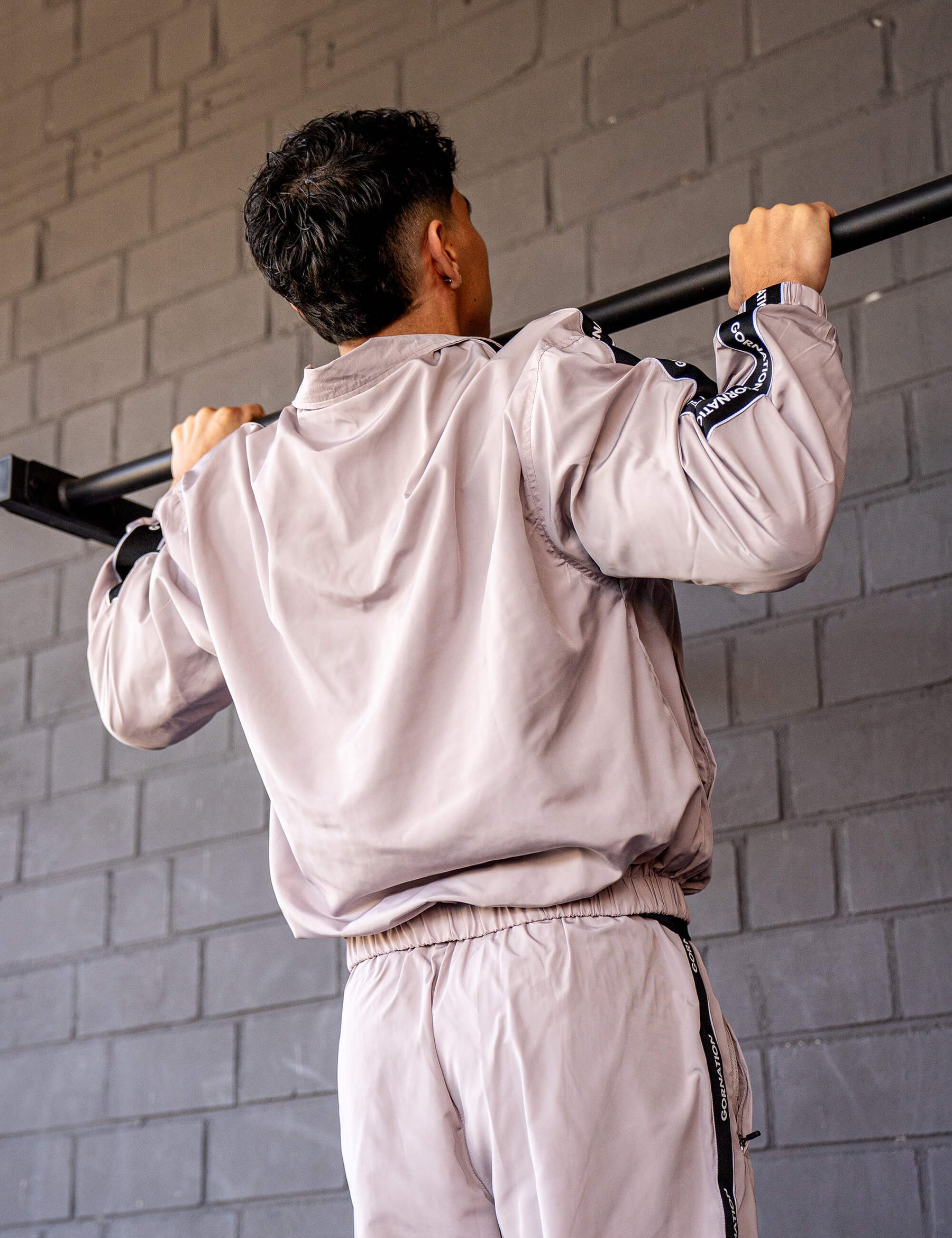 GORNATION athlete doing pull ups on a GORNATION pull up bar wearing a tracksuite