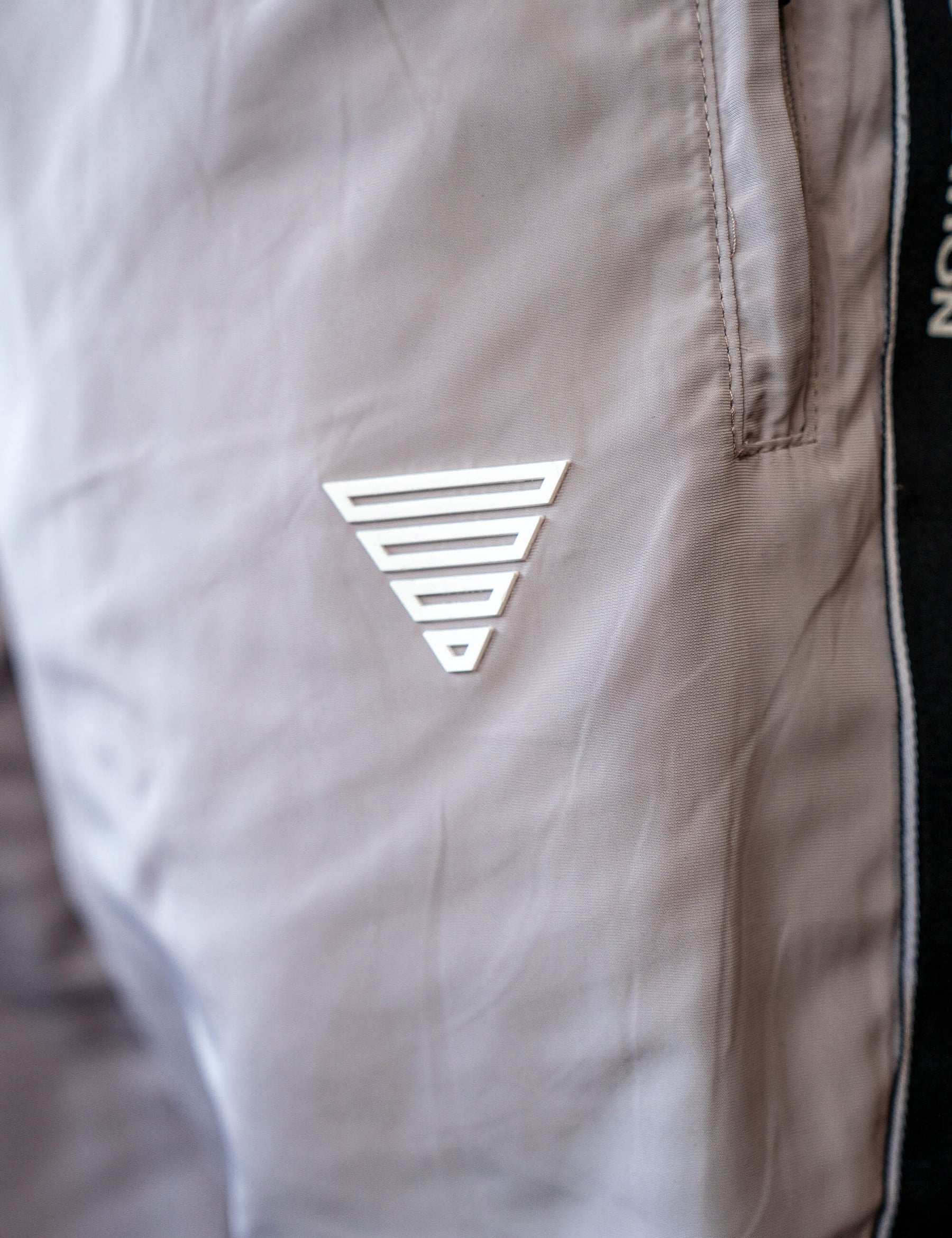Close up of a GORNATION athlete wearing the GORNATION tracksuite pants in grey