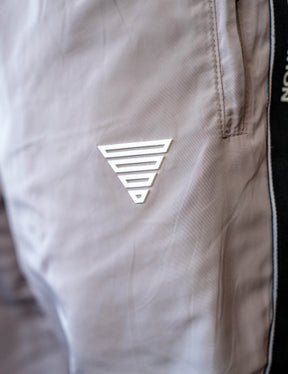 Close up of a GORNATION athlete wearing the GORNATION tracksuite pants in grey