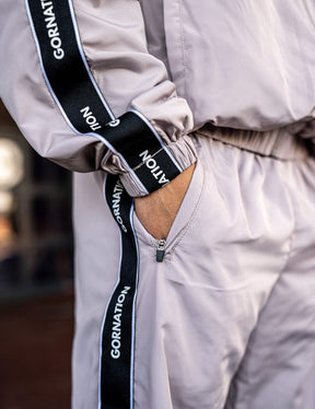 Close up of a GORNATION athlete wearing the GORNATION tracksuite pants in grey