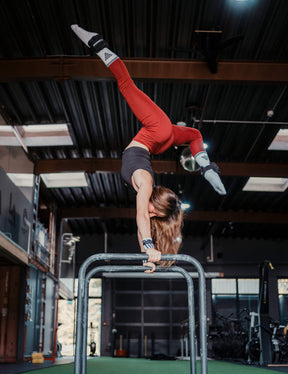 Calisthenics Athlete Jasi performing a handstand with additional weights on her Ankle