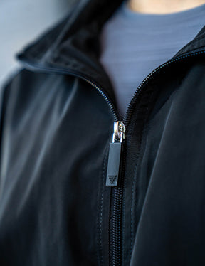 Close up of a GORNATION athlete wearing the GORNATION tracksuite jacket in black
