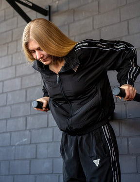 GORNATION athlete doing dips on GORNATION dip bars wearing a tracksuite