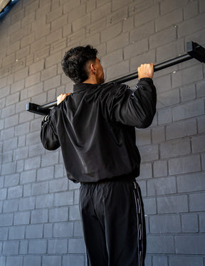 GORNATION athlete doing pull ups on a GORNATION pull up bar wearing a tracksuite