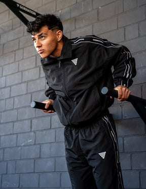 GORNATION athlete doing dips on GORNATION dip bars wearing a tracksuite