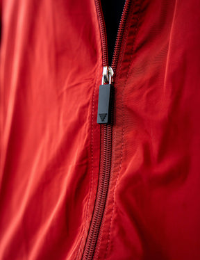 Close up of a GORNATION athlete wearing the GORNATION tracksuite jacket in red