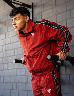 GORNATION athlete doing dips on GORNATION dip bars wearing a tracksuite