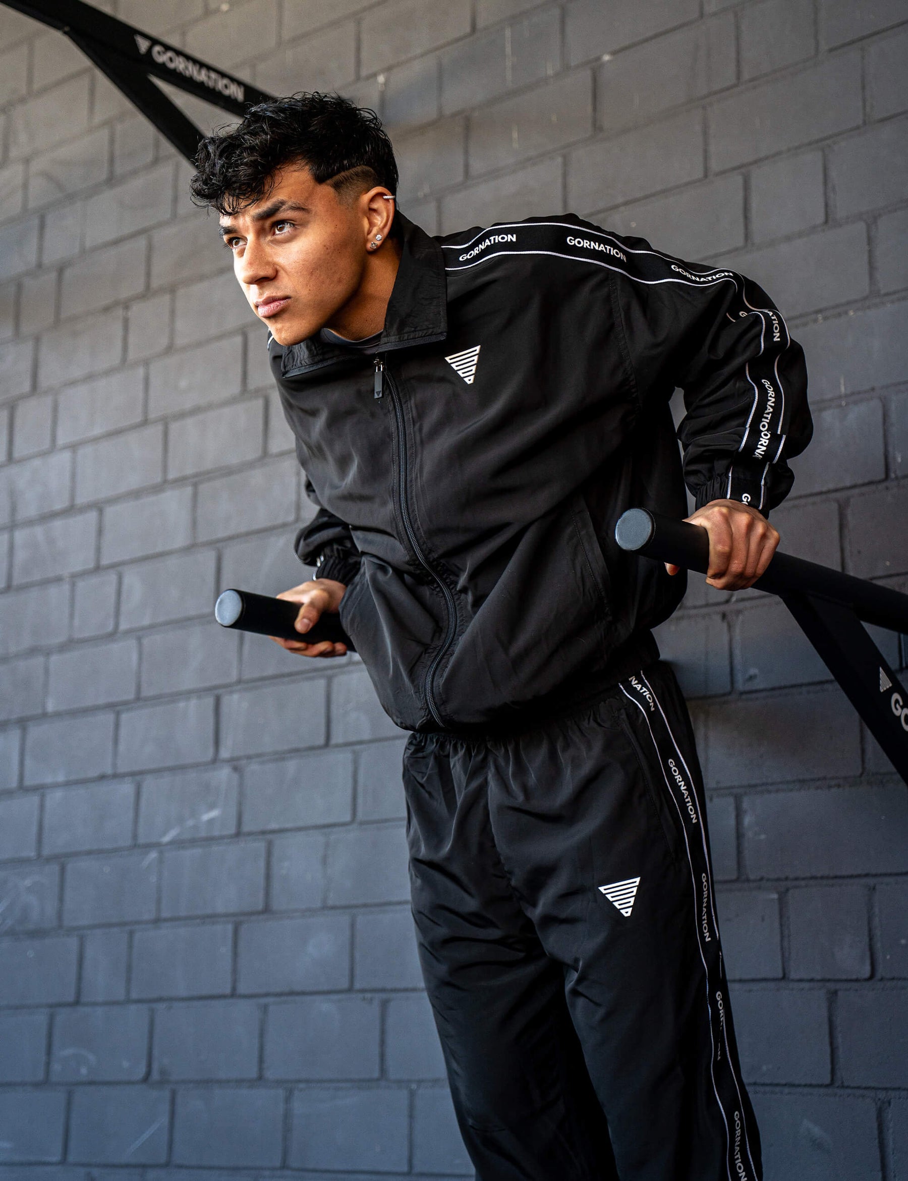 GORNATION athlete doing dips on GORNATION dip bars wearing a tracksuite